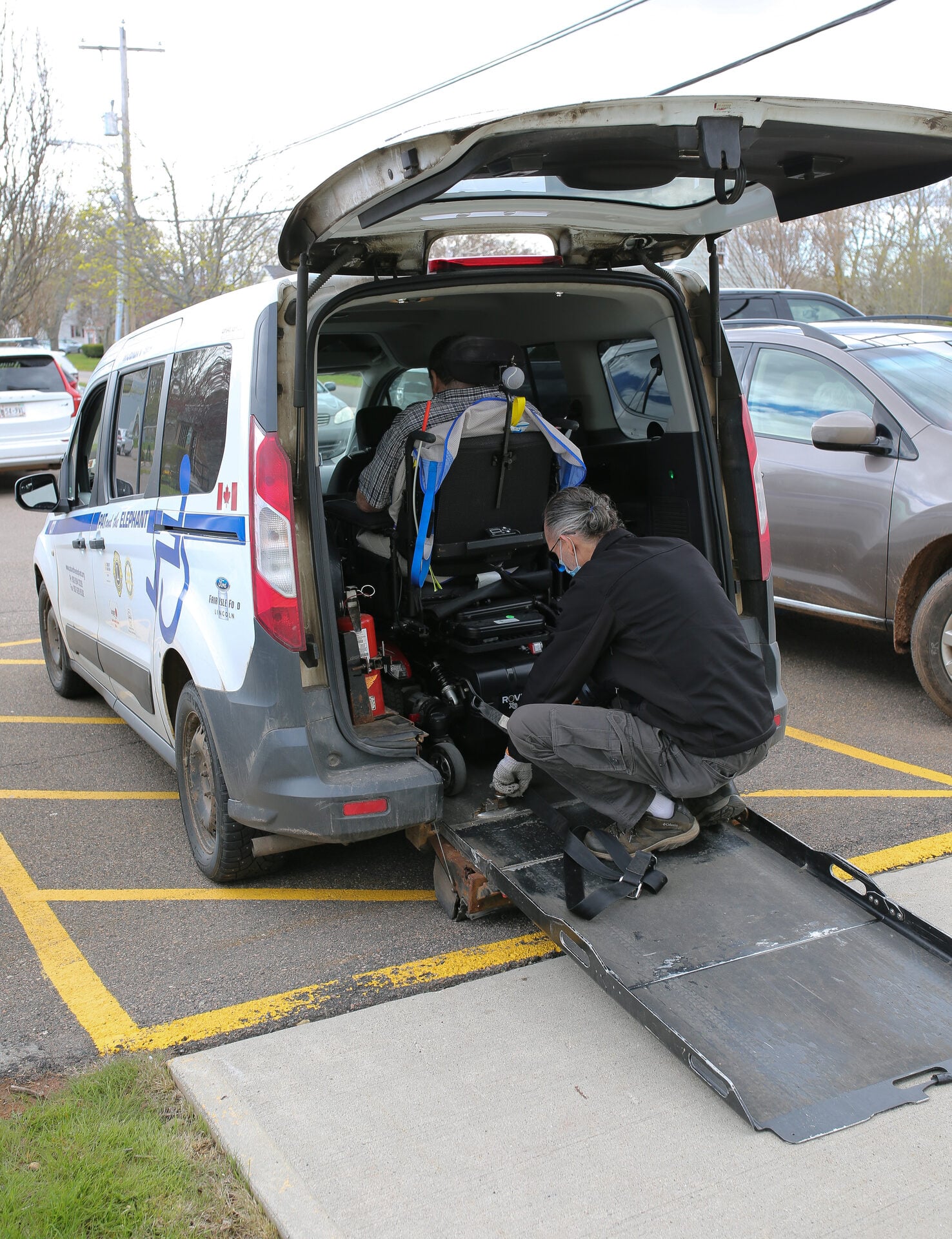 Pat & The Elephant team member with vehicle, professional attire, Charlottetown PEI setting