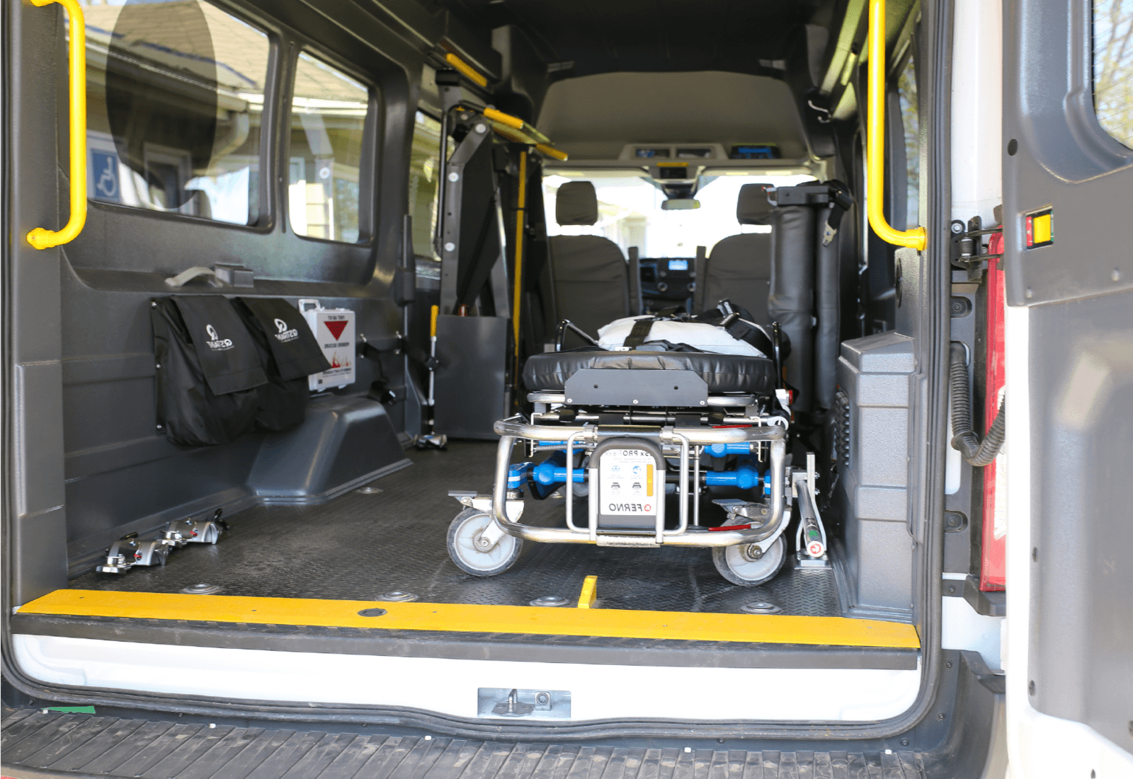 Pat & The Elephant stretcher transport vehicle with medical equipment, clean white interior visible, professional medical transport setup